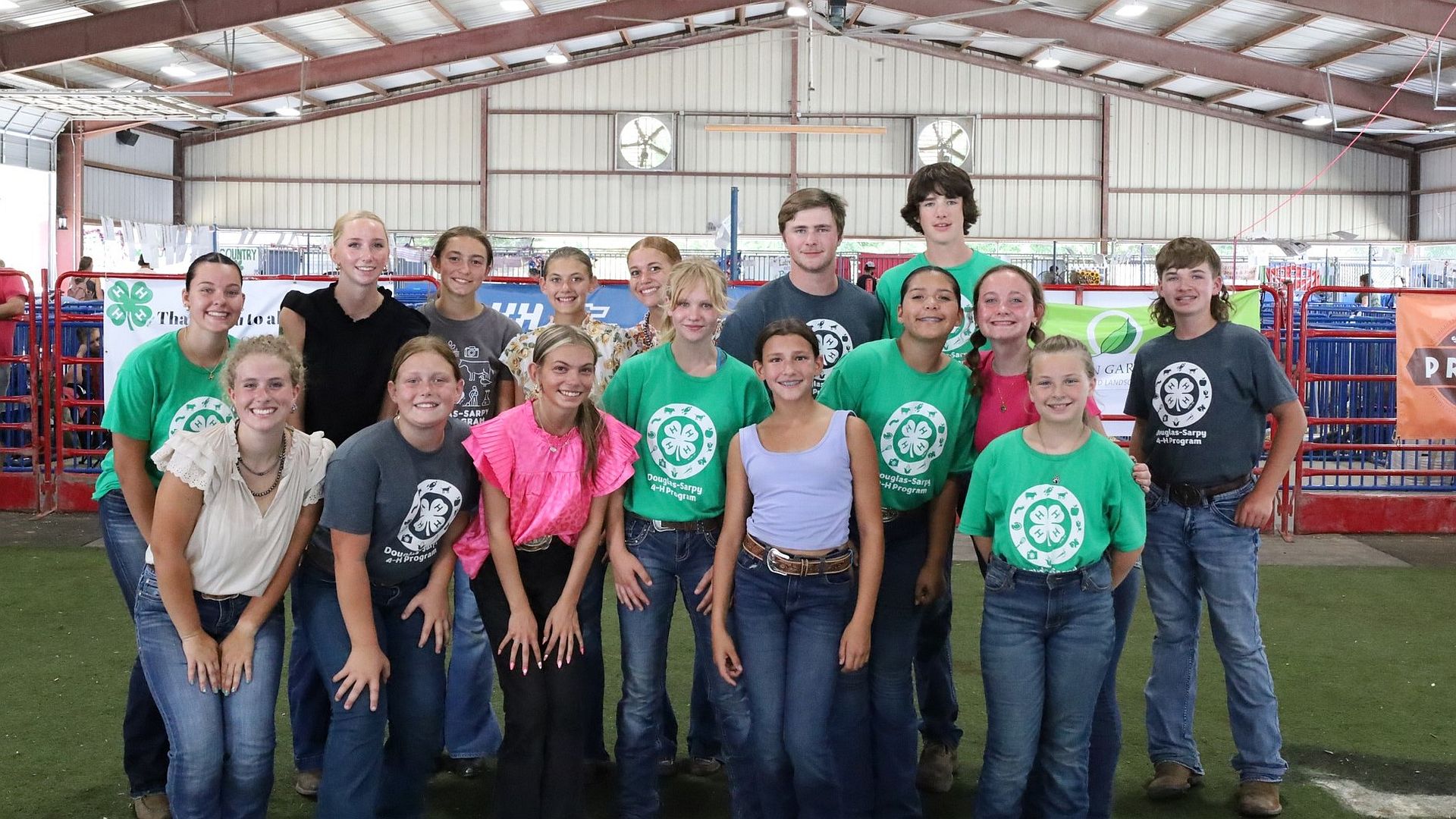 4-H members posing for a picture in a building at the Sarpy County Fair.