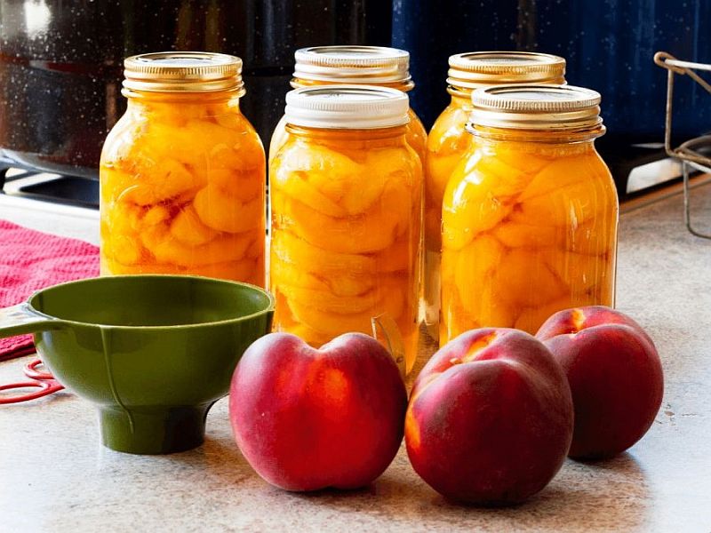 Image of canning jars, a funnel, and apples.