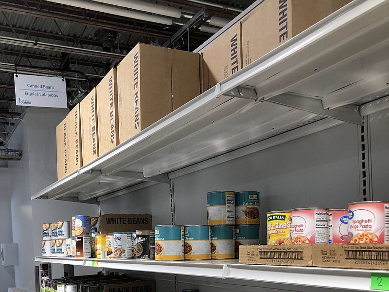 Shelves of can goods and boxes in a food pantry.