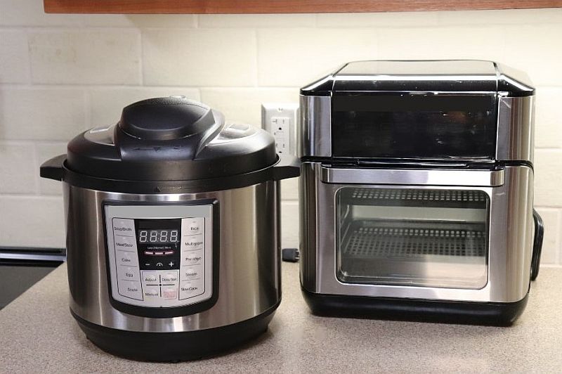 Image of an air fryer and multi-cooker on a kitchen countertop.