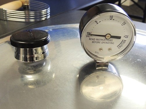 Image of a pressure canner lid with gauge.