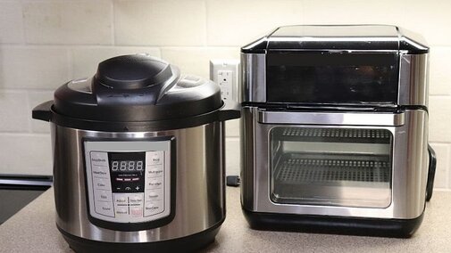 Image of an air fryer and multi-cooker on a kitchen countertop.