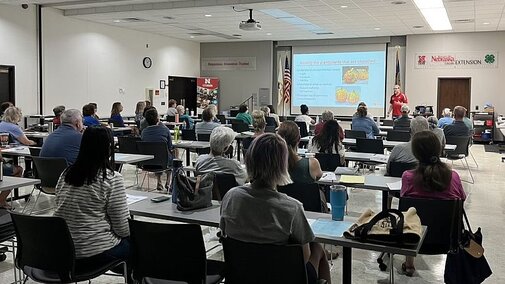People in a meeting room watching a presentation.
